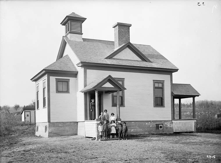 Unidentified school, group of children standing on and in front of the steps, vicinity of Woodstock, New Brunswick, date unknown