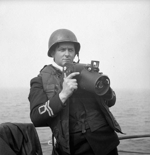 Lieutenant Gilbert A. Milne of the Royal Canadian Naval Volunteer Reserve, holding a Fairchild K20 camera